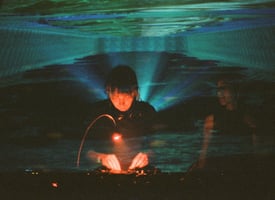 Image of a DJ mixing in a club