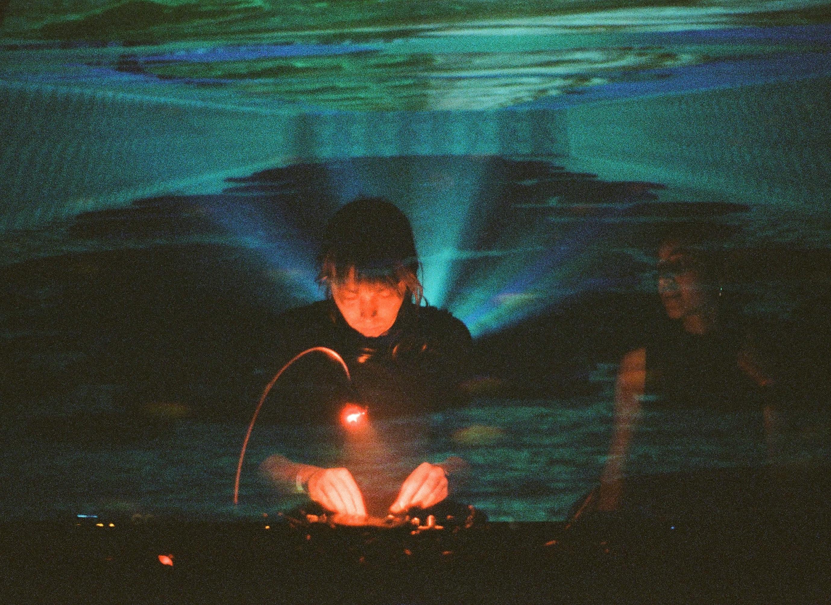 Image of a DJ mixing in a club